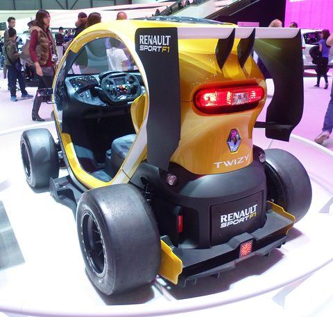 Rear of a yellow and black open racer with a large wing, a red tail lamp and Renault Sport lettering. Opens a larger view